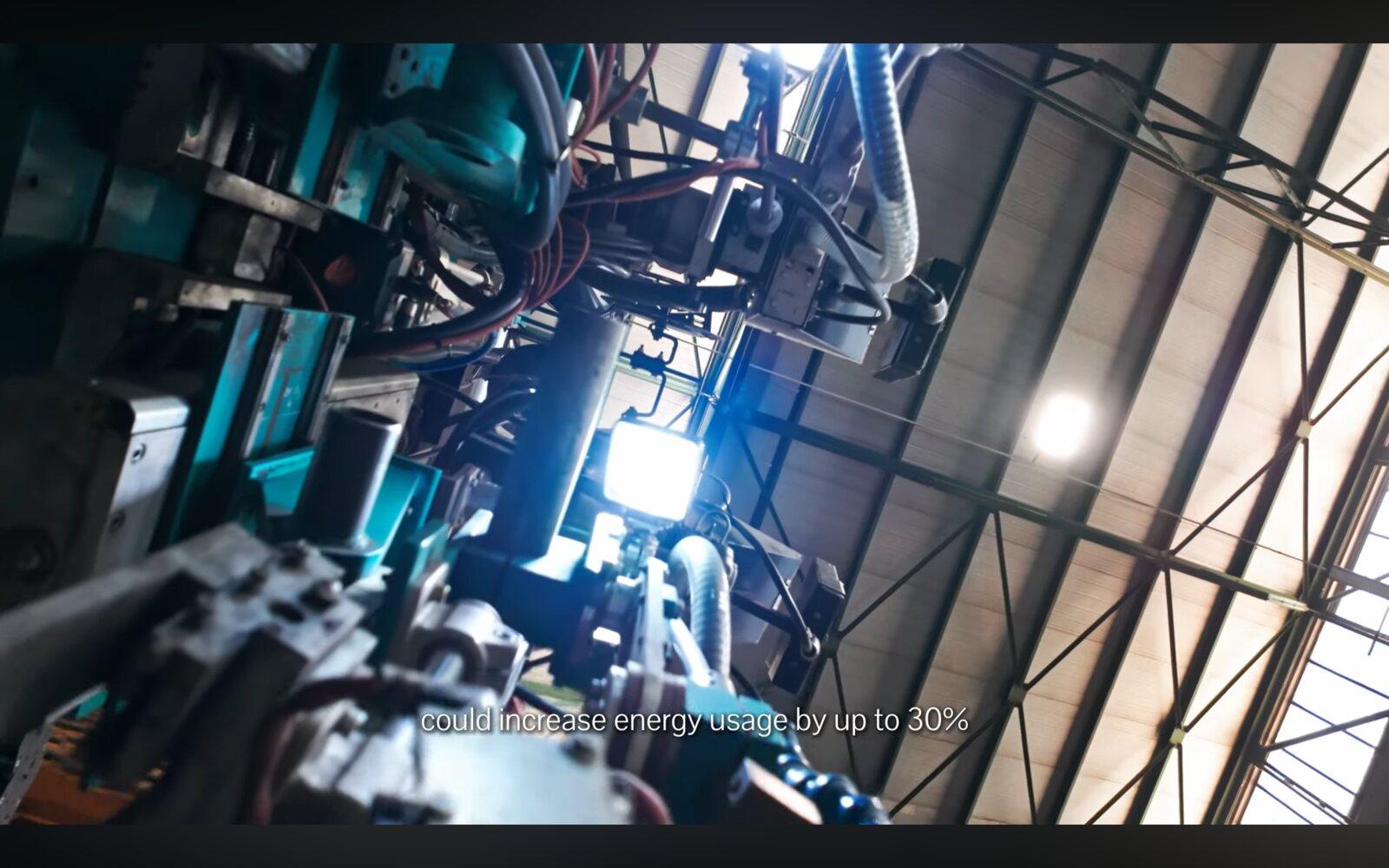 Framegrab — process/machinery footage with on-screen type.